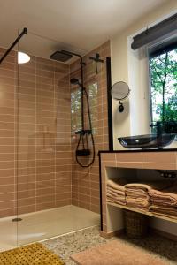 a bathroom with a glass shower and a sink at Willow Hideaway in Arendonk
