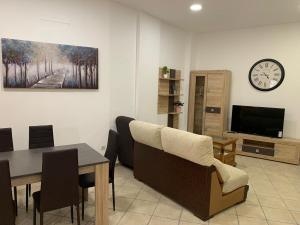 a living room with a dining table and a tv at Apartamento centro ciudad in Algeciras
