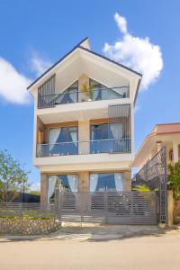 a house with balconies on the side of it at Happy Home Da Lat in Da Lat