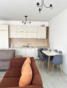 a living room with a couch and a table at Sunflower Apartments in Prishtinë