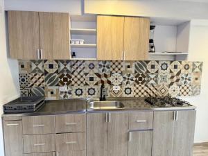 a kitchen with a sink and a counter top at Ciudad Mallorquin in Puerto Colombia