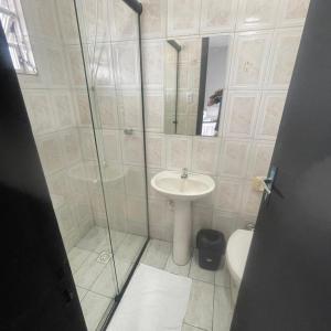 a bathroom with a shower and a sink and a toilet at Pousada Siri do Mar in Pontal do Paraná