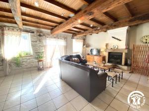 a living room with a couch and a table at Dame nature in La Tourette-Cabardès