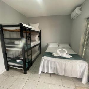 a bedroom with a bed with two swans on it at Pousada Siri do Mar in Pontal do Paraná