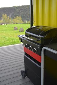 a grill sitting on a deck next to a field at ILLU Resort in Orhei