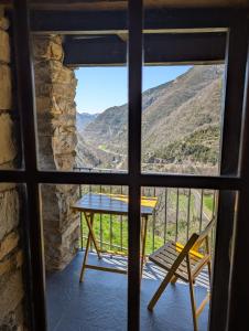 a view from a window of a table and a chair at Casa Rústica y Chic con Chimenea y Vistas Panorámicas de La Vall de Boí in Cardet
