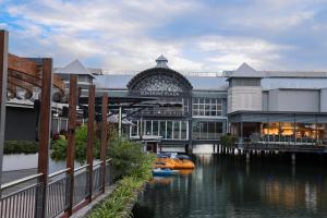 a large building with a boat in the water at Maroochydore Penthouse - Stunning Views- 2Carparks in Maroochydore