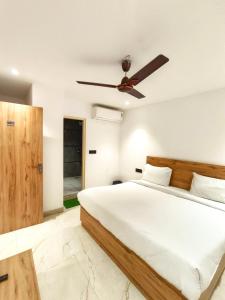 a bedroom with a bed and a ceiling fan at Hotel Star City Delhi - Near IGI Airport & Aerocity in New Delhi