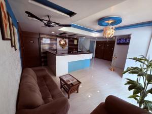 a living room with a couch and a kitchen at Hotel Arya Residency Rabale in Airoli
