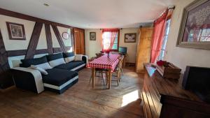 a living room with a couch and a table at Les Perles du Ried - Gîte 202 in Boofzheim