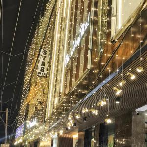 a bunch of lights hanging from the side of a building at Hotel Star City Delhi - Near IGI Airport & Aerocity in New Delhi