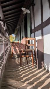a wooden bench sitting on a porch of a building at Les Perles du Ried - Gîte 202 in Boofzheim +27 photos