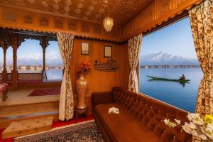 a living room with a couch and a large window at halloween palace in Srinagar