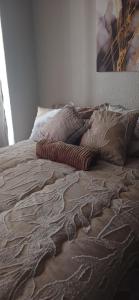 a bed with a blanket and pillows on it at Stylish Bachelor with Oak Floors & View in Johannesburg