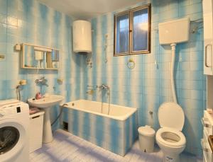 a bathroom with a toilet and a tub and a sink at Small Hill Guesthouse in Podgorica +27 photos