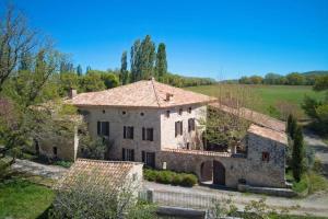 an aerial view of a large stone house at Mas de Thésée Piscine & 12 ha privés in Reillanne +19 photos