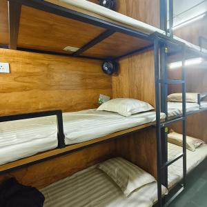 a bunk bed room with three bunk beds in it at Hans Dormitory in Mumbai