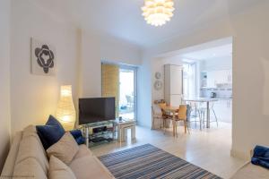 a living room with a couch and a tv at Stones Throw in Woolacombe