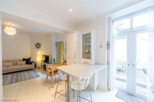 a kitchen and living room with a table and chairs at Stones Throw in Woolacombe