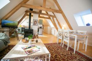 una sala de estar con una mesa y un sofá en Aux Roses et aux Poutres, en Le Tremblay-le-Vicomte