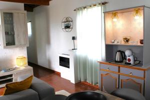 a living room with a couch and a table at Azores Panorama Lodge in Norte Pequeno