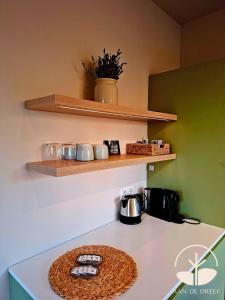 a kitchen with a counter with a coffee pot on it at aan de Dreef in Zundert +14 photos