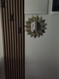 a mirror on a wall with a white wall at Apartmant Novaković in Vrnjačka Banja
