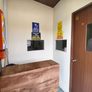 a room with signs on the wall and a door at Hans Dormitory in Mumbai