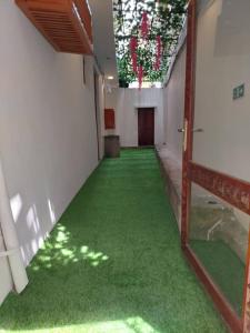 an empty hallway with green flooring in a building at Bellimena Stone Town in Zanzibar City
