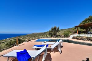 a villa with a pool and a view of the ocean at Dammusi Sciuvechi in Pantelleria