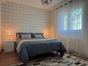 a bedroom with a bed and a window at Casa Abetos in Collado Mediano