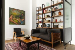 a living room with a couch and a book shelf at Centrale Lustica Bay by Angsana in Radovići