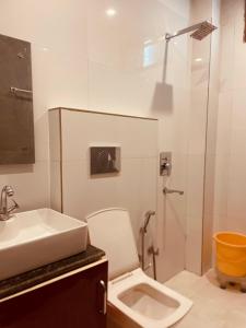a bathroom with a toilet and a sink and a shower at The Orio Cloudberry Kasauli in Kasauli +25 photos