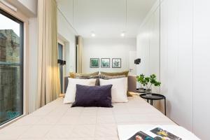 a bedroom with a large bed with pillows at Mennica Residence - City Center by Renters Prestige in Warsaw