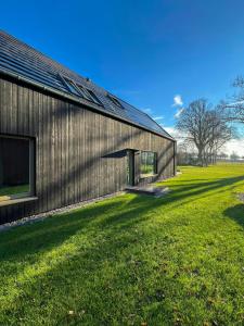 a large building with a grass field next to it at Architect's House With Nature View 