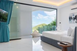 a bedroom with a bed and a large window at Sea View Chaweng Noi Villa Luxury in Chaweng Noi Beach +39 photos