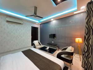 a hotel room with a bed and a tv at Sky Light Inn Hotel in Gurgaon +18 photos