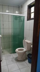 a bathroom with a toilet and a glass shower at SacodoCeu2026 in Angra dos Reis