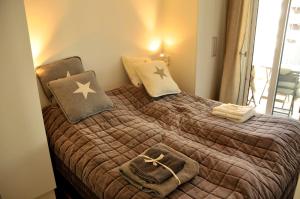 a bedroom with a bed with a blanket and pillows at Seafront Luxury In Oslo in Oslo