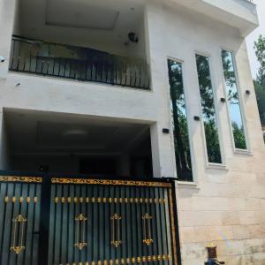 a front door of a house with a gate at AlFalah Guest House in Murree