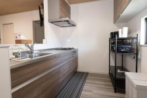 a kitchen with a sink and a microwave at FabulousOdawara in Odawara