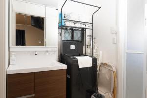 a black refrigerator in a kitchen with a sink at FabulousOdawara in Odawara +27 photos