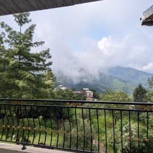 a balcony with a view of a mountain at AlFalah Guest House in Murree +11 photos
