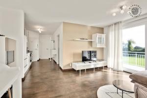 a living room with a large window and a table at ! NEU ! Markgraf Premium Apartments - Bad Bellingen in Bad Bellingen