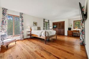 a bedroom with a bed and a wooden floor at RMR: Lake Creek Cottage Home in The Aspens in Wilson