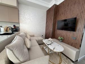 a living room with a couch and a table at Modern spaces 12 in Yunusobod