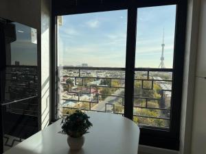a view of the eiffel tower from a window at Modern spaces 12 in Yunusobod