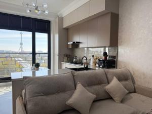 a living room with a couch and a kitchen at Modern spaces 12 in Yunusobod