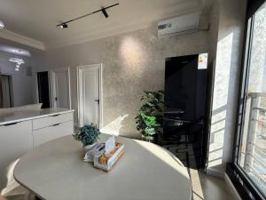 a kitchen with a table and a counter top at Modern spaces 12 in Yunusobod +25 photos