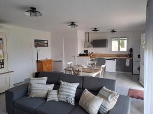 a living room with a couch and a kitchen at Kerhuella in Saint-Ségal